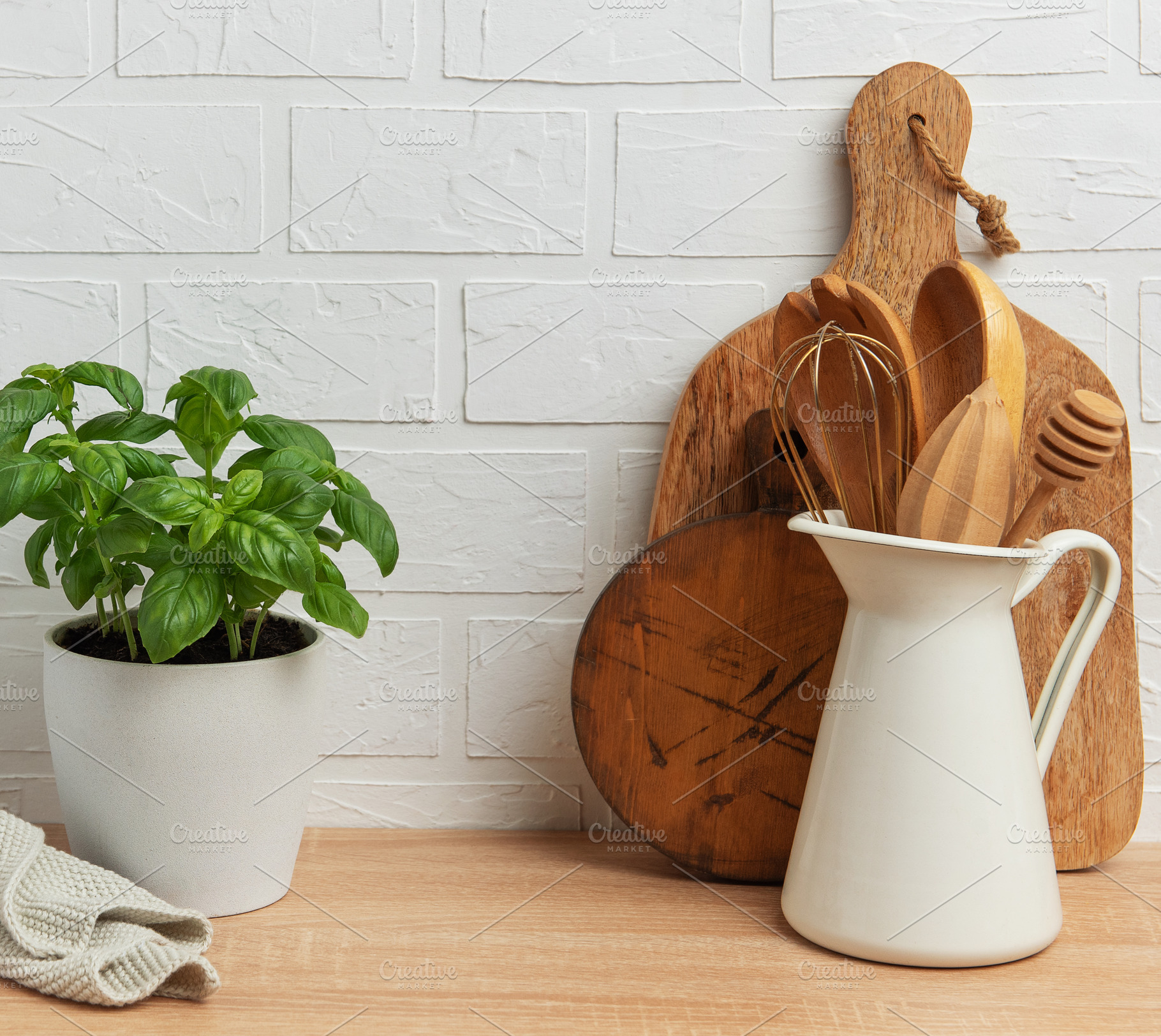 Kitchen utensils and basil plant creating a rustic culinary scen, a Food & Drink Photo by Olena Rudo