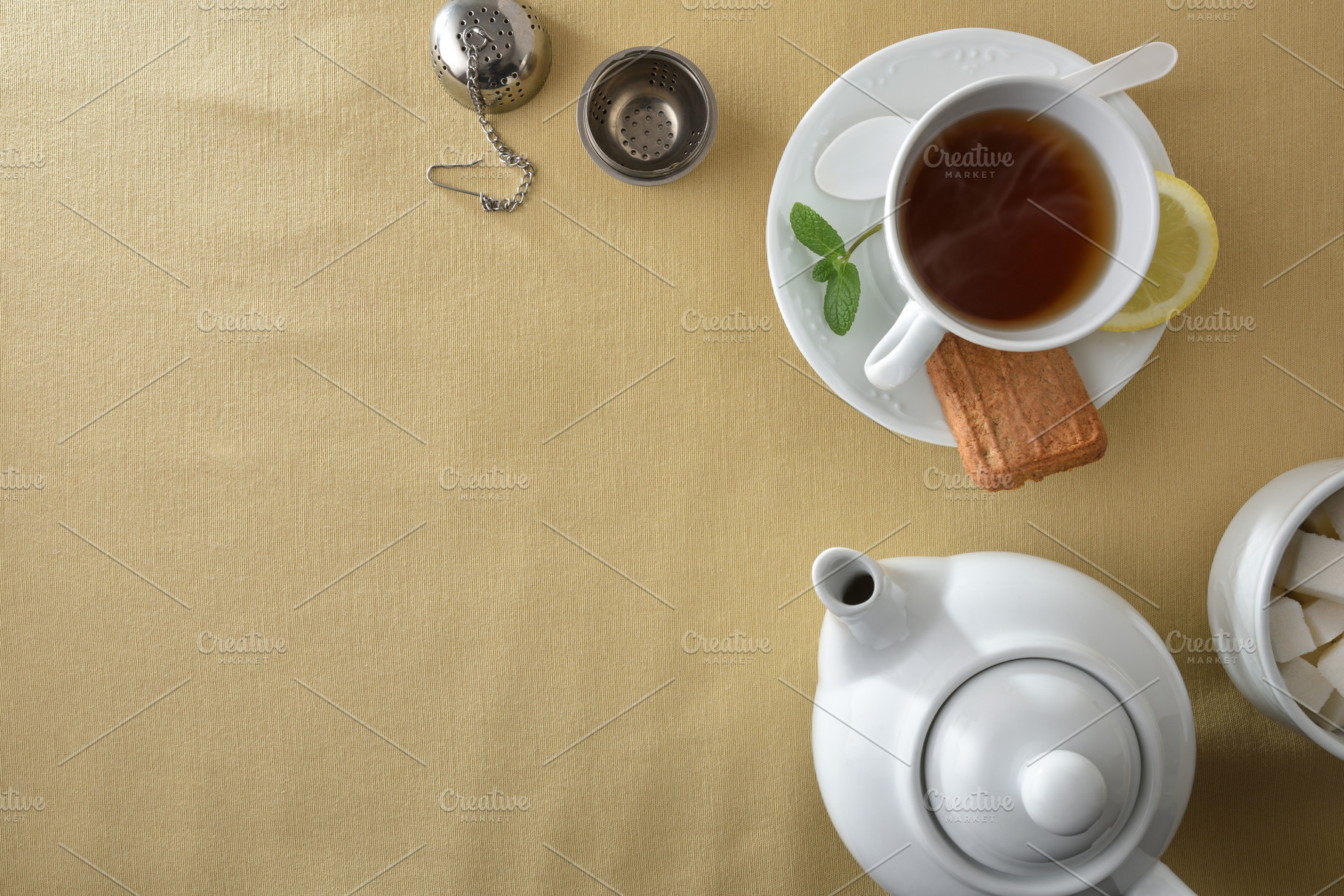 Tea and white ceramic containers on a table with tablecloth, a Food & Drink Photo by Davizro's Market