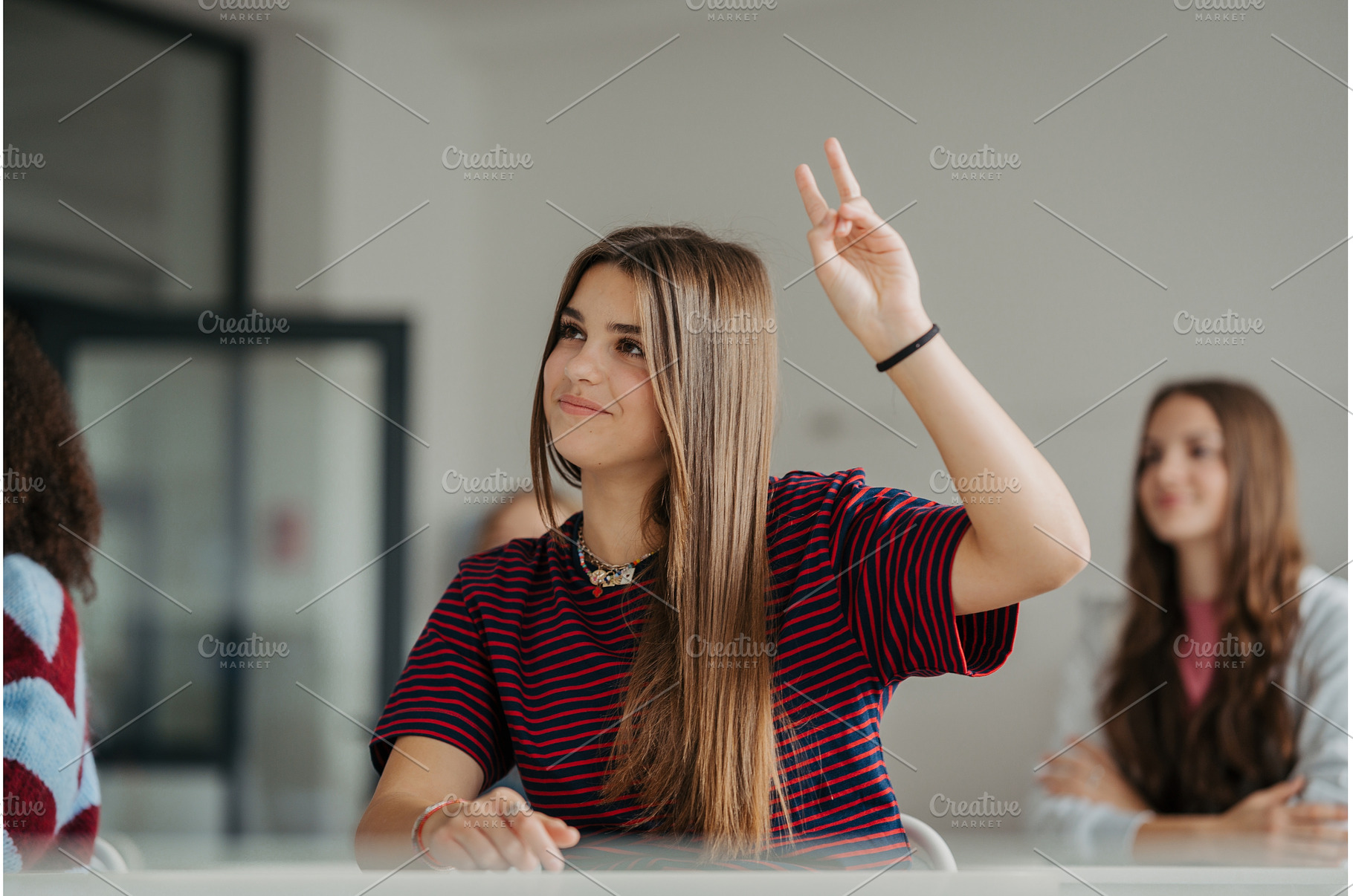 Girl student raising a hand to, a School & Education Photo by HalfPoint