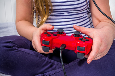 Llittle child kid girl playing video games, a Photo by Rimma