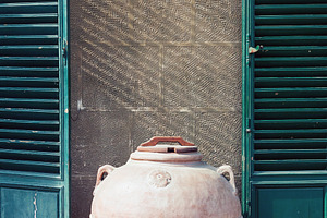Antique roman clay jar by the wall, an Architecture Photo by BOOCYS
