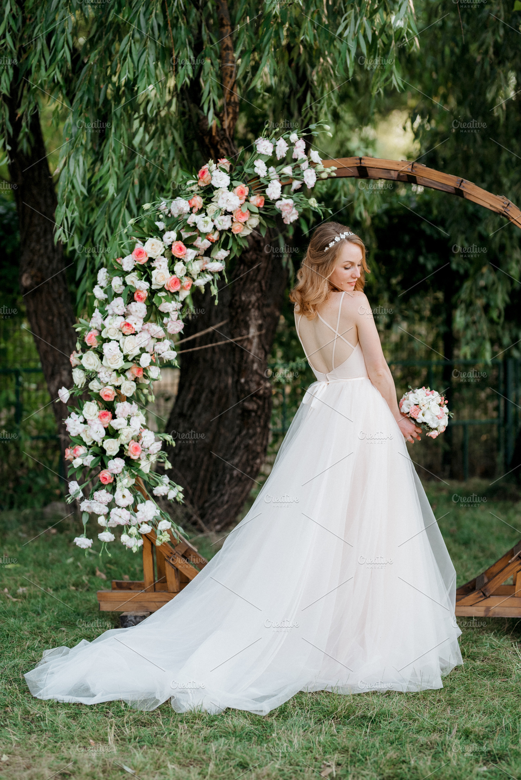 A bride in a coral dress with a bouquet against the backdrop of, a Person Photo by Weddings, People, Travel