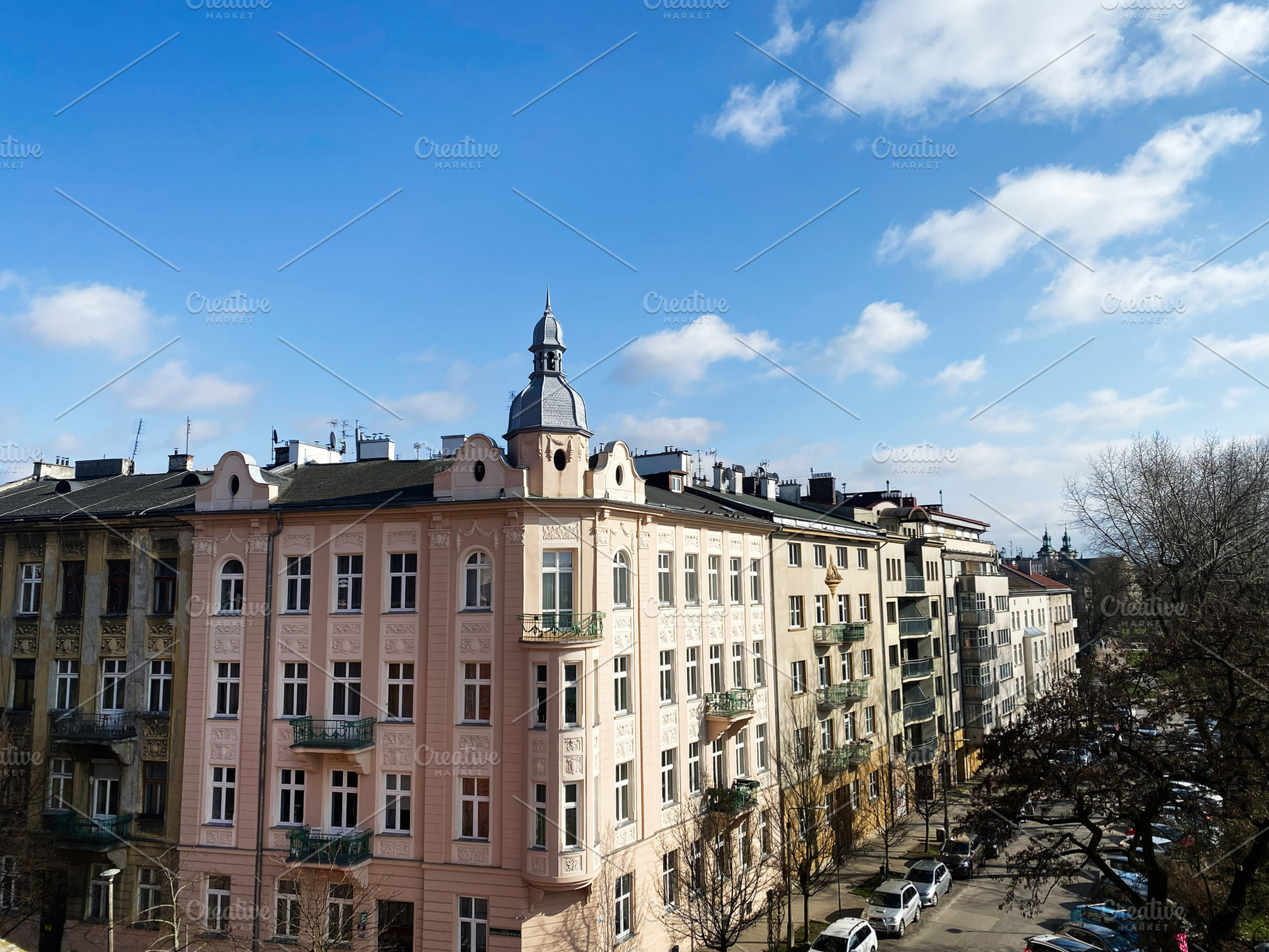 Historic architecture of Krakow Poland under bright blue sky with scattered clo, a Photo by AS photostudio