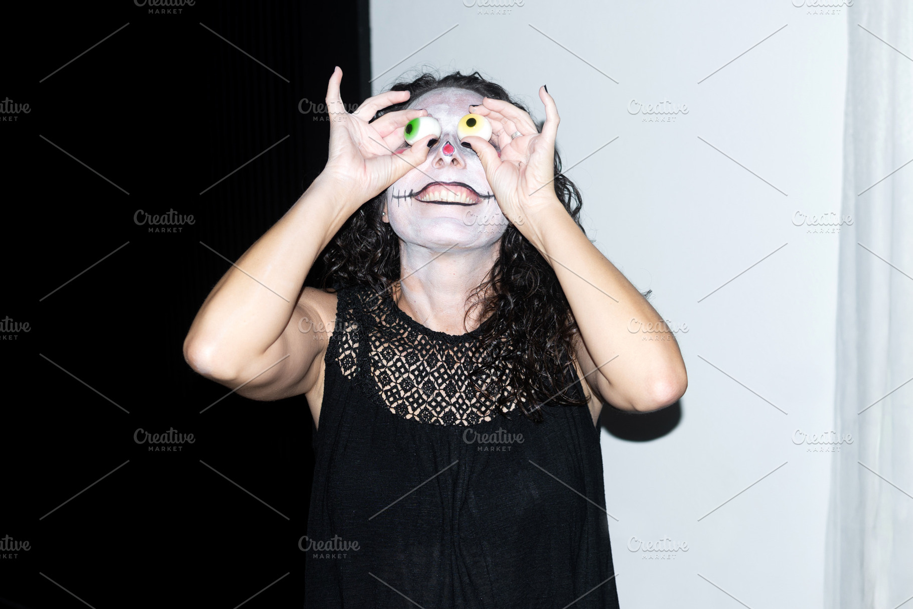 Woman in witch hat posing with Halloween eyeballs, a Person Photo by etorres69