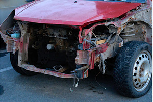 A red car stands in a parking lot, a Transportation Photo by darksoul72