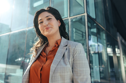 Carefree busineswoman smiling at the camera outdoors, a Person Photo by Jacob Lund