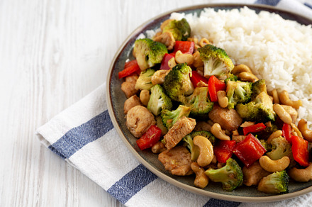 Homemade Cashew Chicken Stir-Fry on a Plate, side view. Copy spa, a Food & Drink Photo by LiudmylaChuhunova