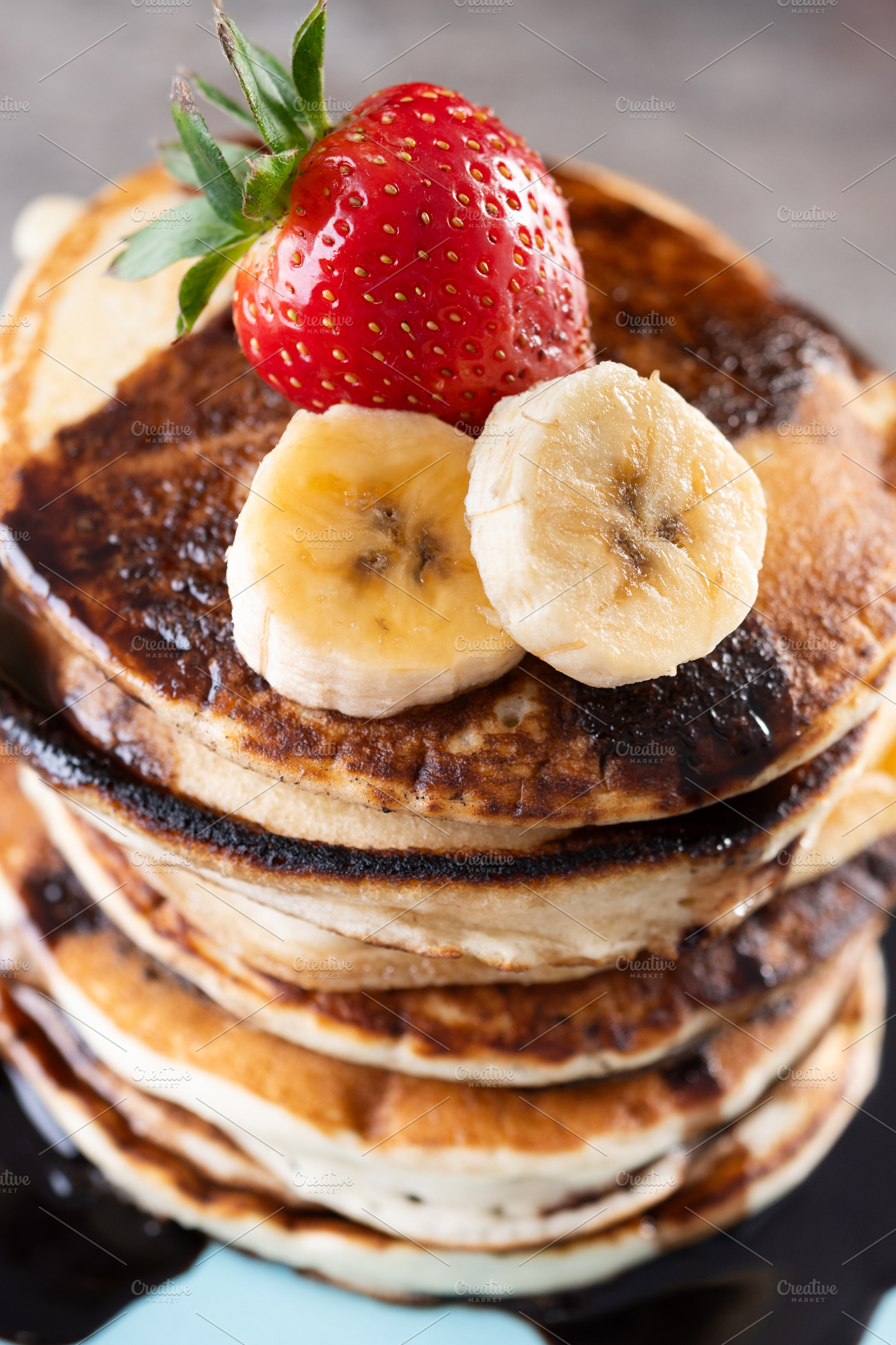 Pancakes with chocolate and fruit on wooden table, a Food & Drink Photo by etorres69