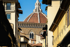 Brunelleschi's Dome rising above Ponte Vecchio in Florence, an Architecture Photo by Antonio Gravante Market