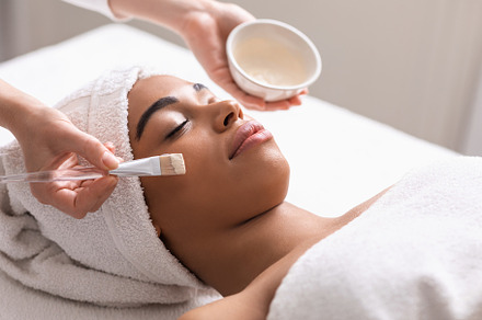 Spa therapist applying face mask for, a Photo by Prostock-Studio