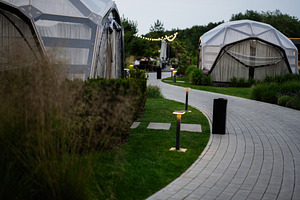 Curved path surrounded by geodesic domes with soft lighting, a Photo by AS photostudio