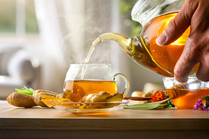 Serving cup of ginger infusion with honey on living room, a Food & Drink Photo by Davizro's Market