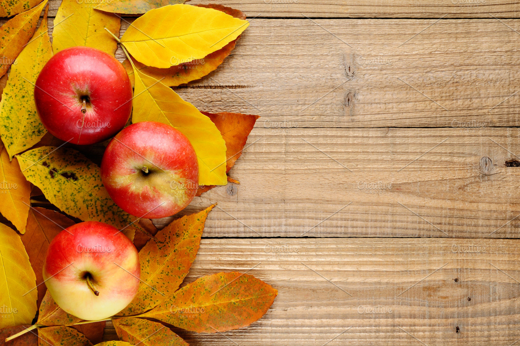 Three Apples On Autumn Leaves