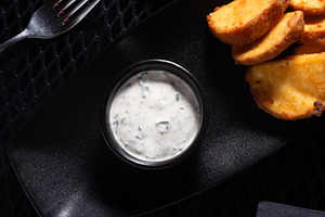 Mayonnaise Sauce with Herbs in Small Bowl on Black Tray, Top Vie, a Photo by MDBildes