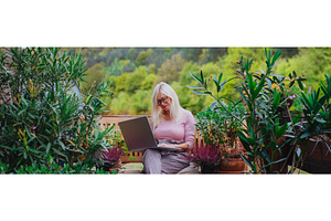 Banner of older woman working from, a Person Photo by HalfPoint