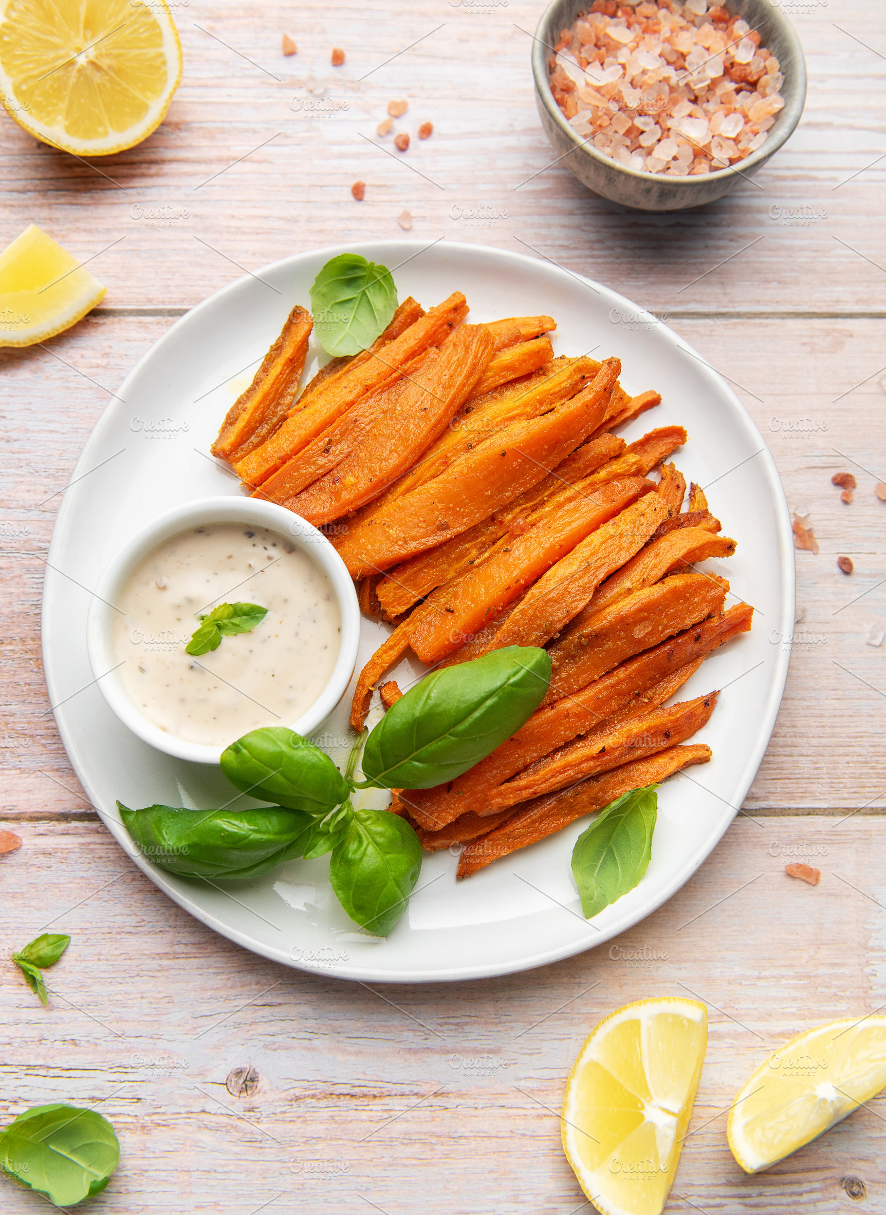 Sweet potato fries with dipping sauce and fresh basil, a Food & Drink Photo by Olena Rudo