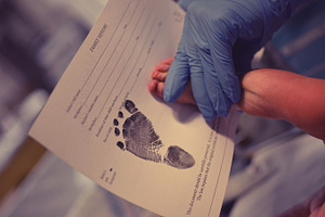 Birth announcement stock photo containing baby and foot