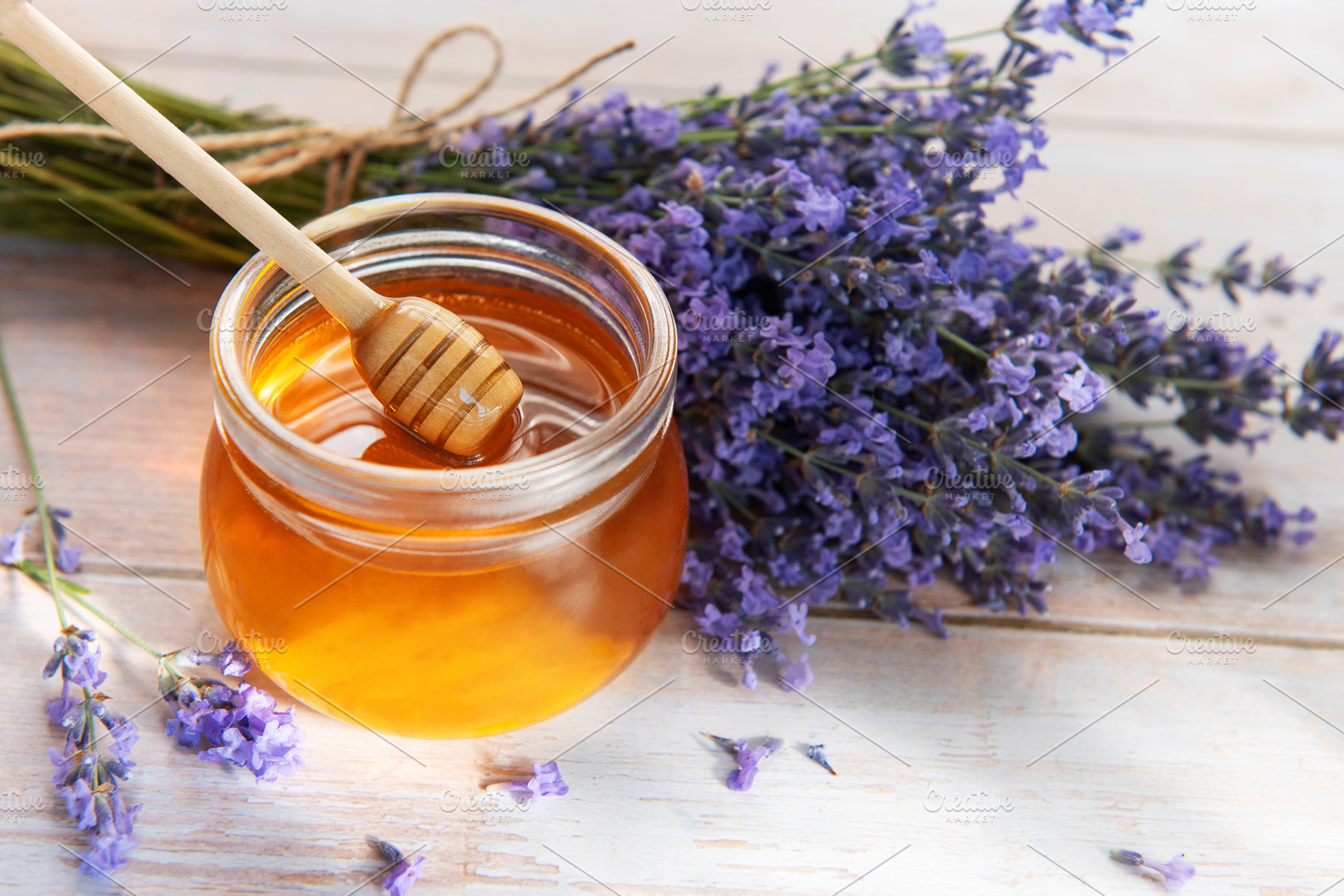 Honey jar with dipper and fresh lavender flowers, a Food & Drink Photo by Olena Rudo