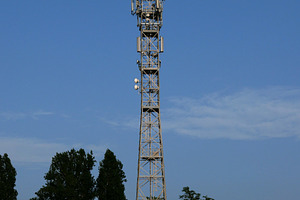communication tower mast over blue sky, a Photo by WorldOfPhotos