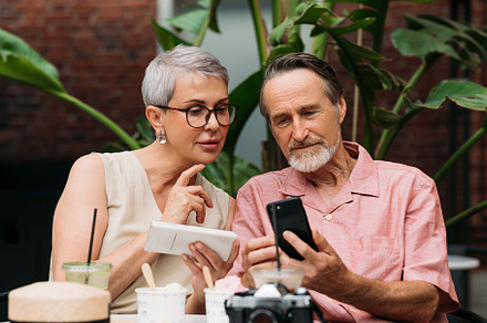 Mature couple using their smartphone, a Person Photo by Artem Varnitsin