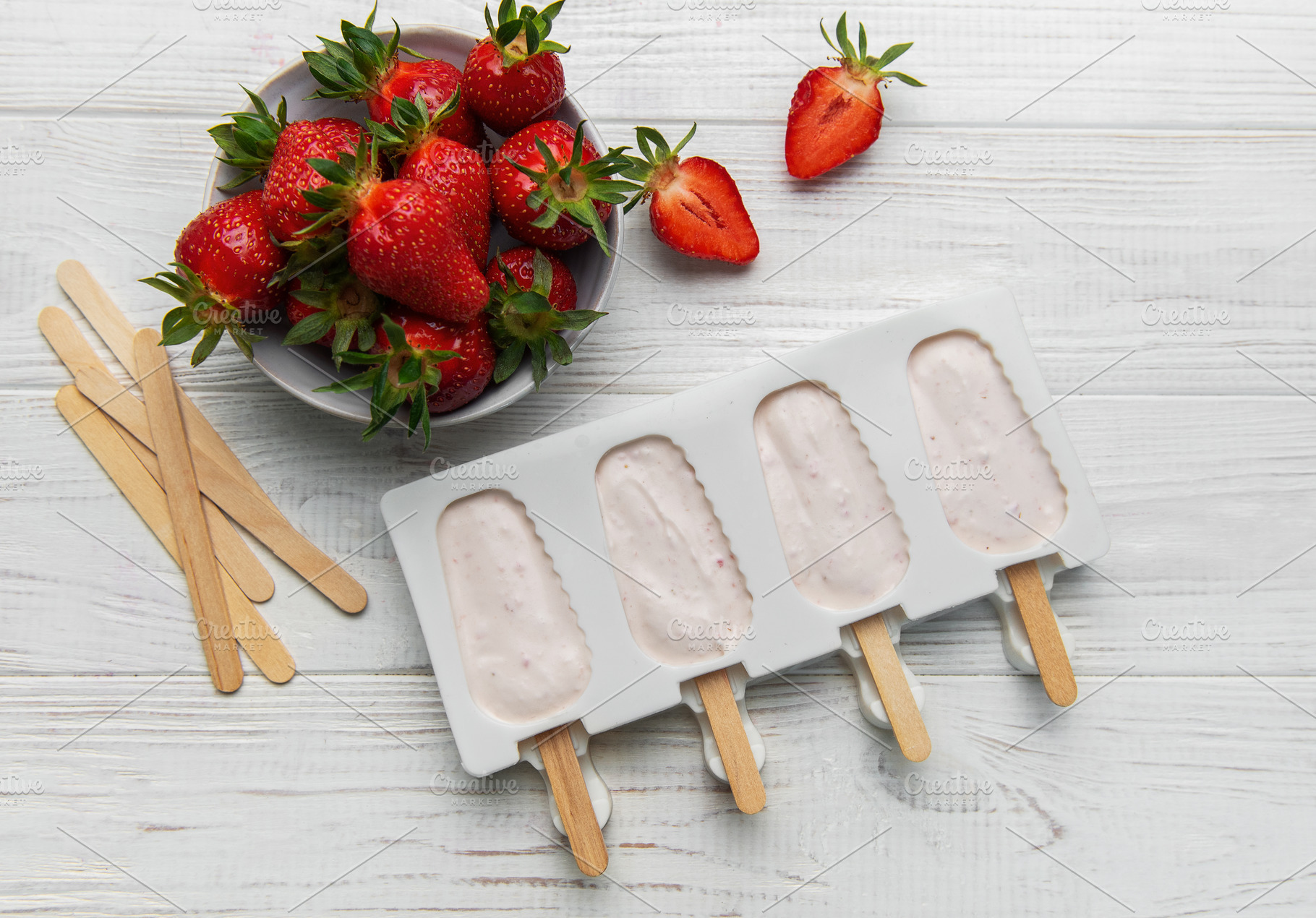 Making strawberry frozen yogurt popsicles for a healthy summer d, a Food & Drink Photo by Olena Rudo