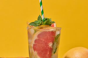 Top of clear glass with cold drink, grapefruit slices, ice and m, a Food & Drink Photo by ndanko