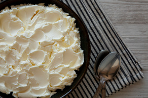 Organic White Mascarpone Cheese in a Bowl, top view., a Food & Drink Photo by LiudmylaChuhunova