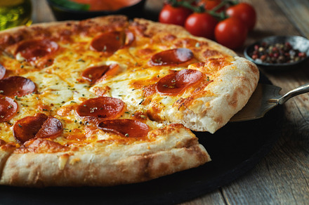A slice of hot Italian pizza with stretching cheese. Pizza pepperoni on a dark, a Food & Drink Photo by Budarinphoto