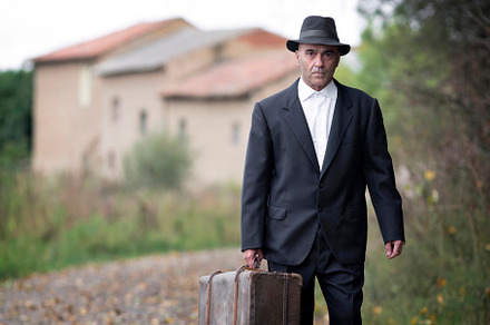 emigrant with suitcase and vintage suit leaving his village to l
