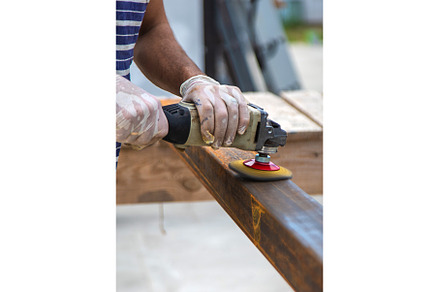 A man processes a metal pole, an Industrial Photo by yanadjana