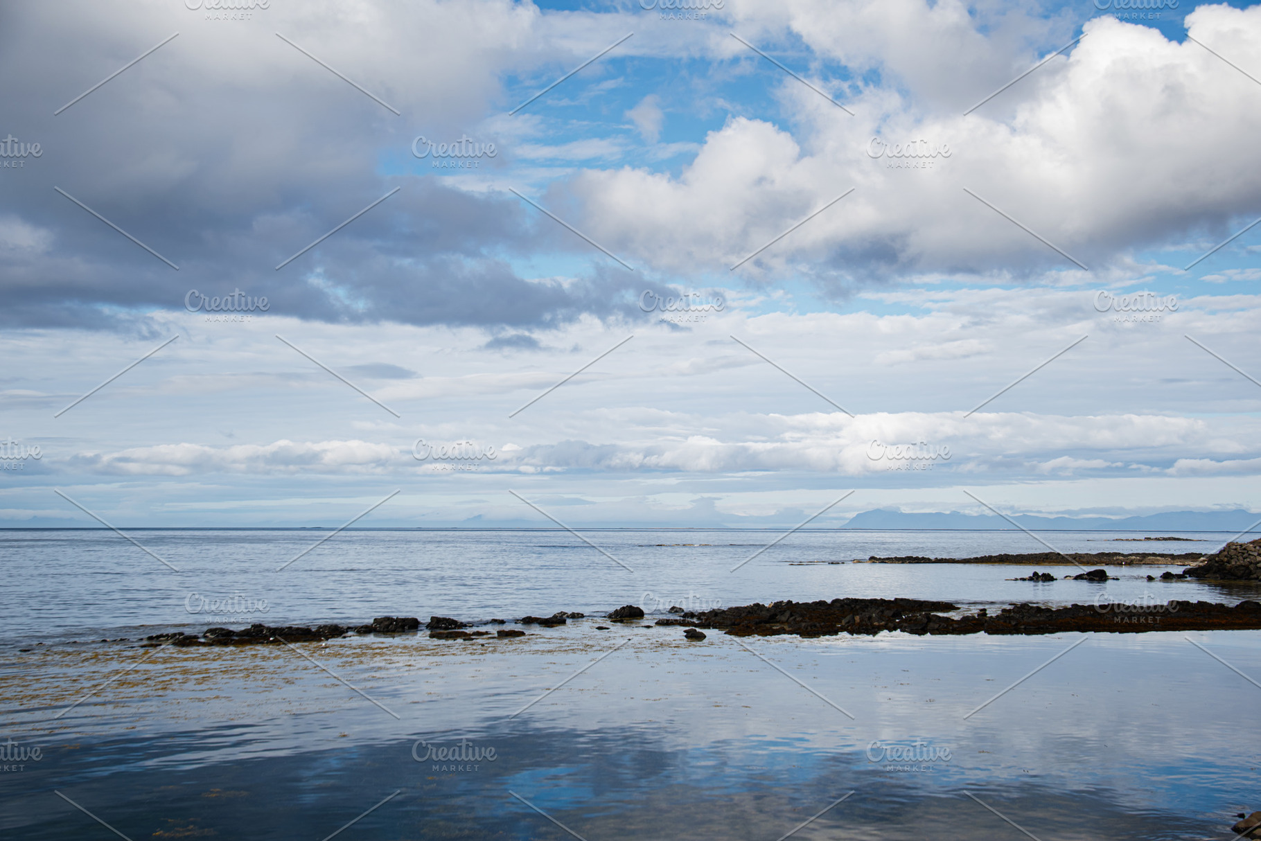 Beautiful coastal view with calm waters and clouds in Iceland's serene setting, a Nature Photo by AS photostudio