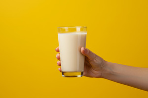 Hand holding a glass of milkshake ag, a Food & Drink Photo by professorinc