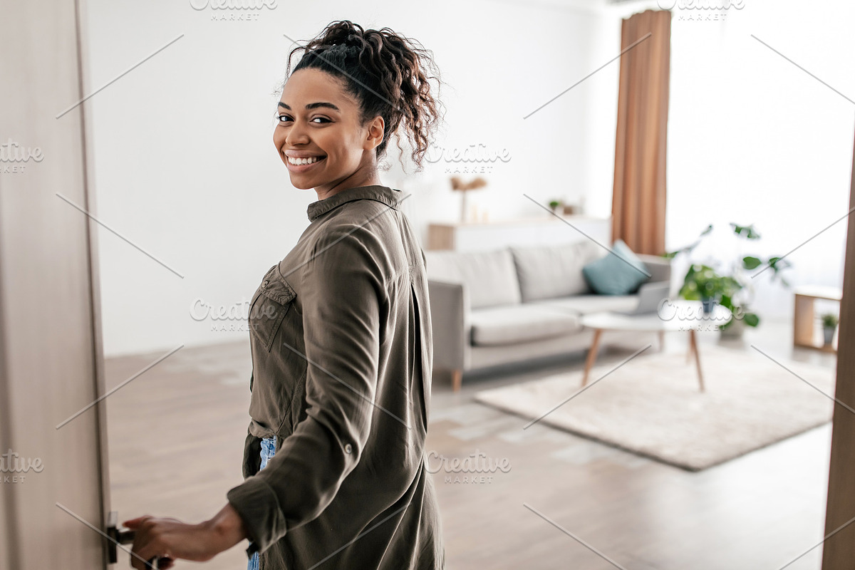 Cheerful Black Female Opening Entry Door Entering Apartment, a Photo by Prostock-Studio (Photo 2 of 2)