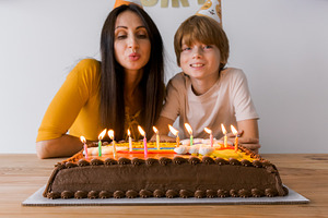 Smiling mother and her young son blo, a Holiday Photo by Kolomiyets Viktoriya