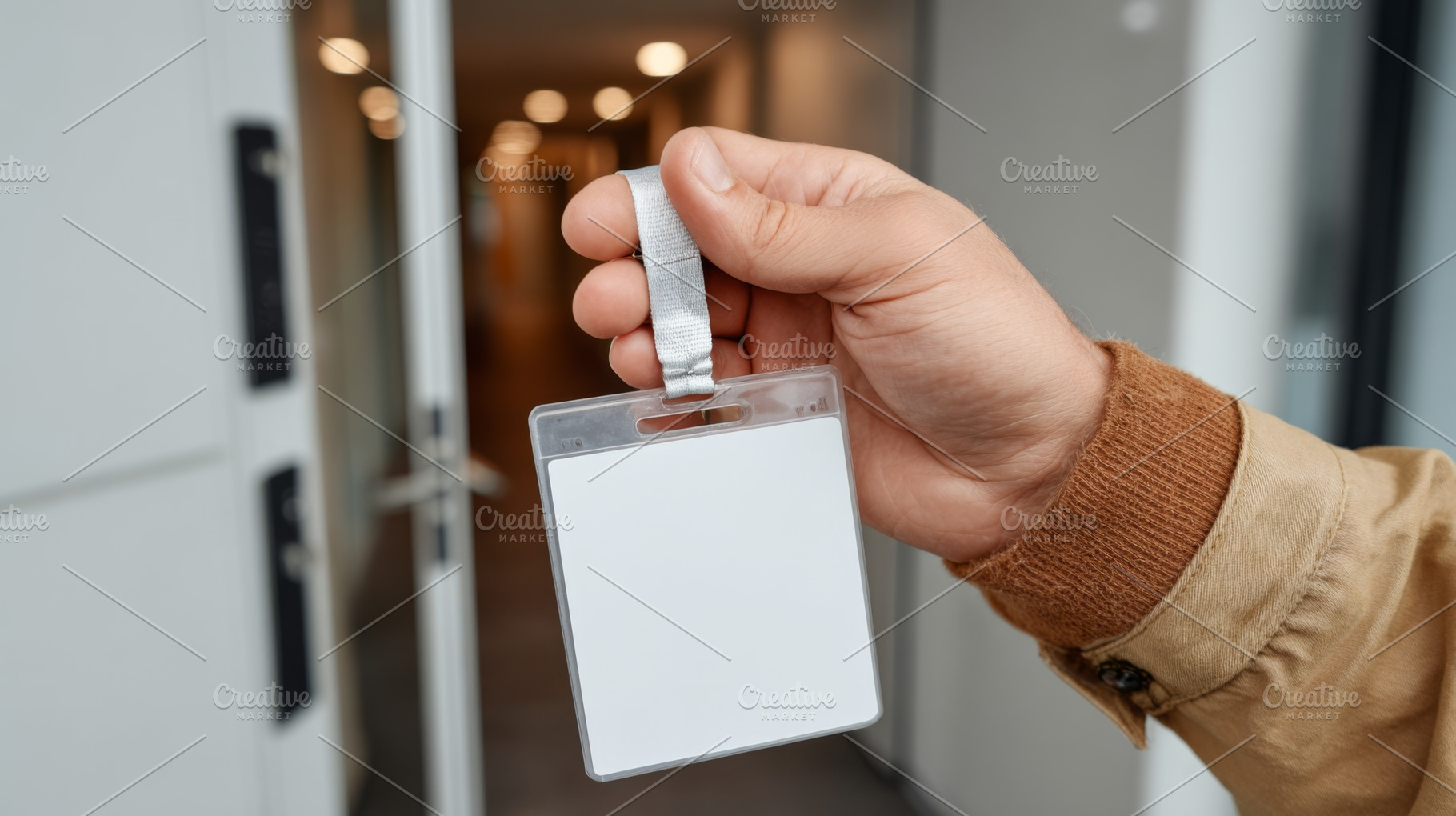 Close-up of a hand holding a blank ID badge in a modern office entrance., a Business Photo by ImageMir