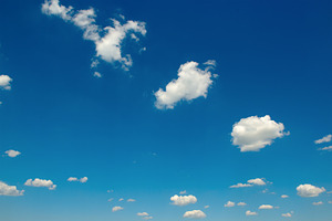 White fluffy clouds and bright sun