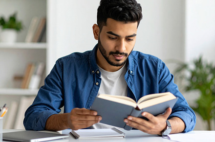 Student deeply concentrated on a book, surrounded by a calm and, a School & Education Photo by DanFLCreativo