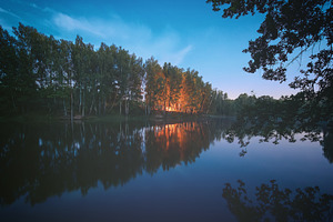 Night landscape with bonfire reflection on water surface, blue s, a Nature Photo by Eugene_Photo