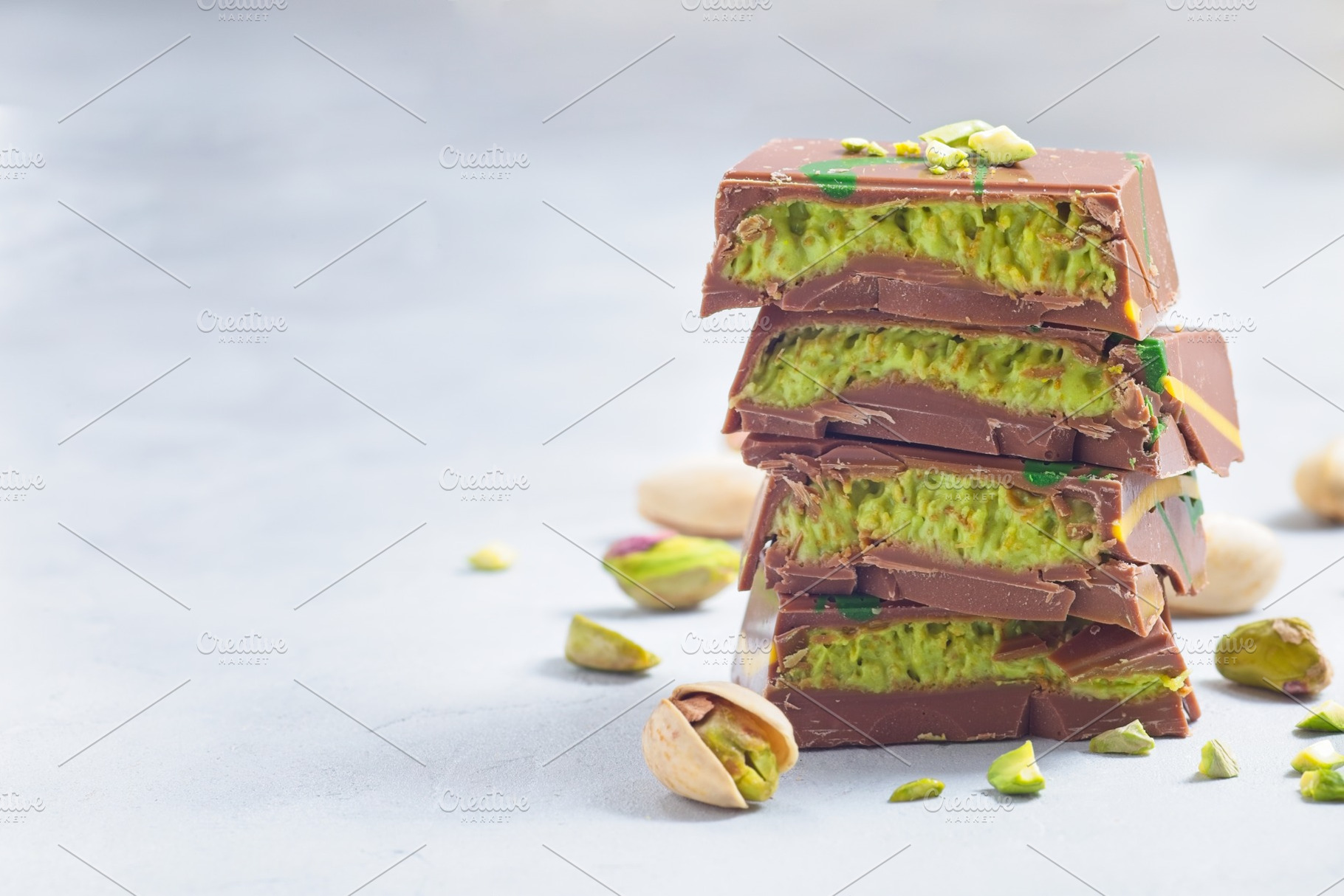Stack of chocolate bars with pistachio and kadaifi filing, horizontal copy spac, a Food & Drink Photo by iuliia_n
