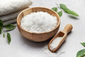 Magnesium flakes in wooden bowl with scoop for spa treatment, a Beauty & Fashion Photo by Olena Rudo