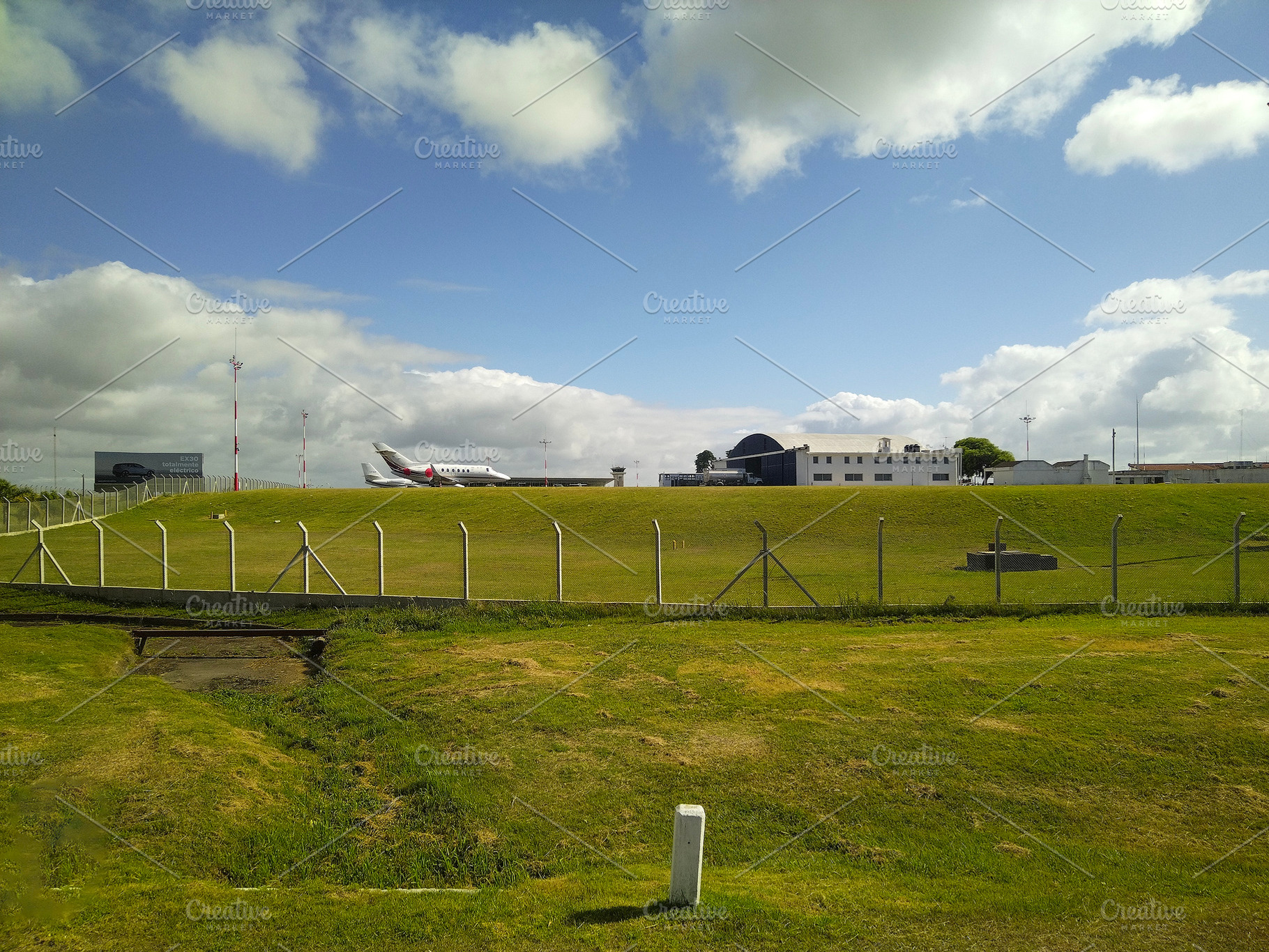 Airplane on runway under blue sky in rural airfield, a Transportation Photo by DanFLCreativo