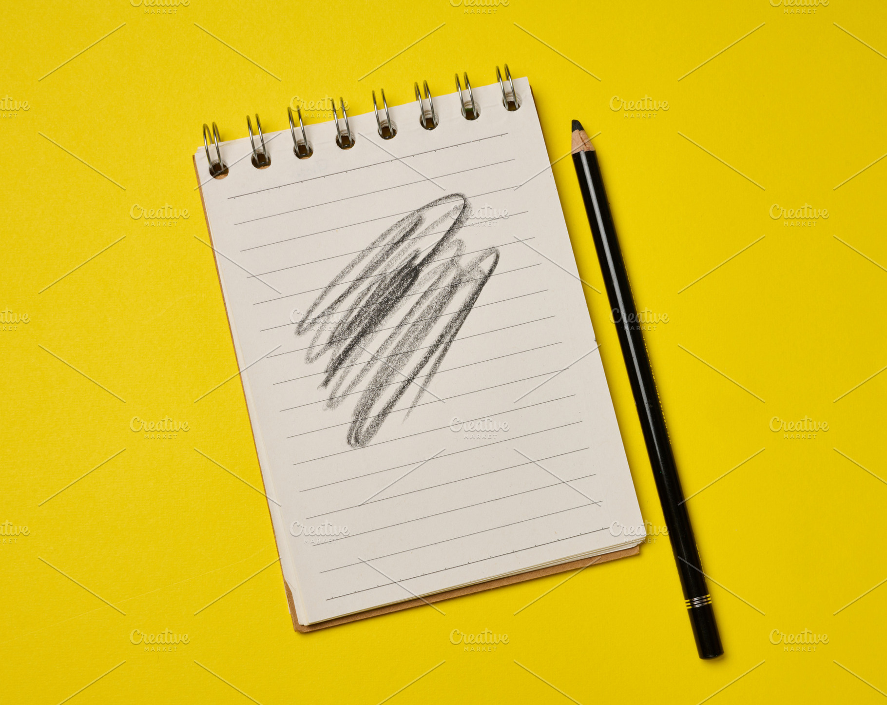 Spiral-bound lined notepad with a black pencil and a scribbled d, a Business Photo by ndanko
