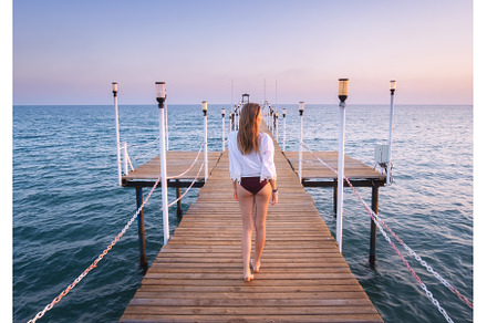 Happy young woman in bikini walking, a Person Photo by den-belitsky