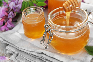 Honey in jars with dipper and acacia flowers, a Food & Drink Photo by Olena Rudo