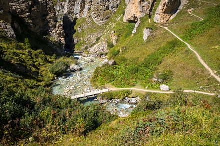 Mountain river and wood bridge in Vanoise national Park valley,, a Nature Photo by GoodGoods