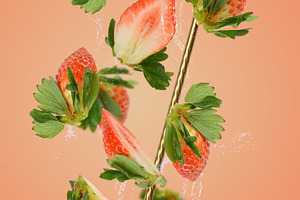 Strawberry halves and splashes of water fly around a golden stra, a Food & Drink Photo by ndanko