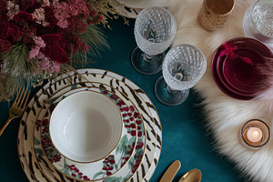 Festive holiday dinner table setting with elegant tableware, ornate glasses, sp, a Food & Drink Photo by Studio ANNA