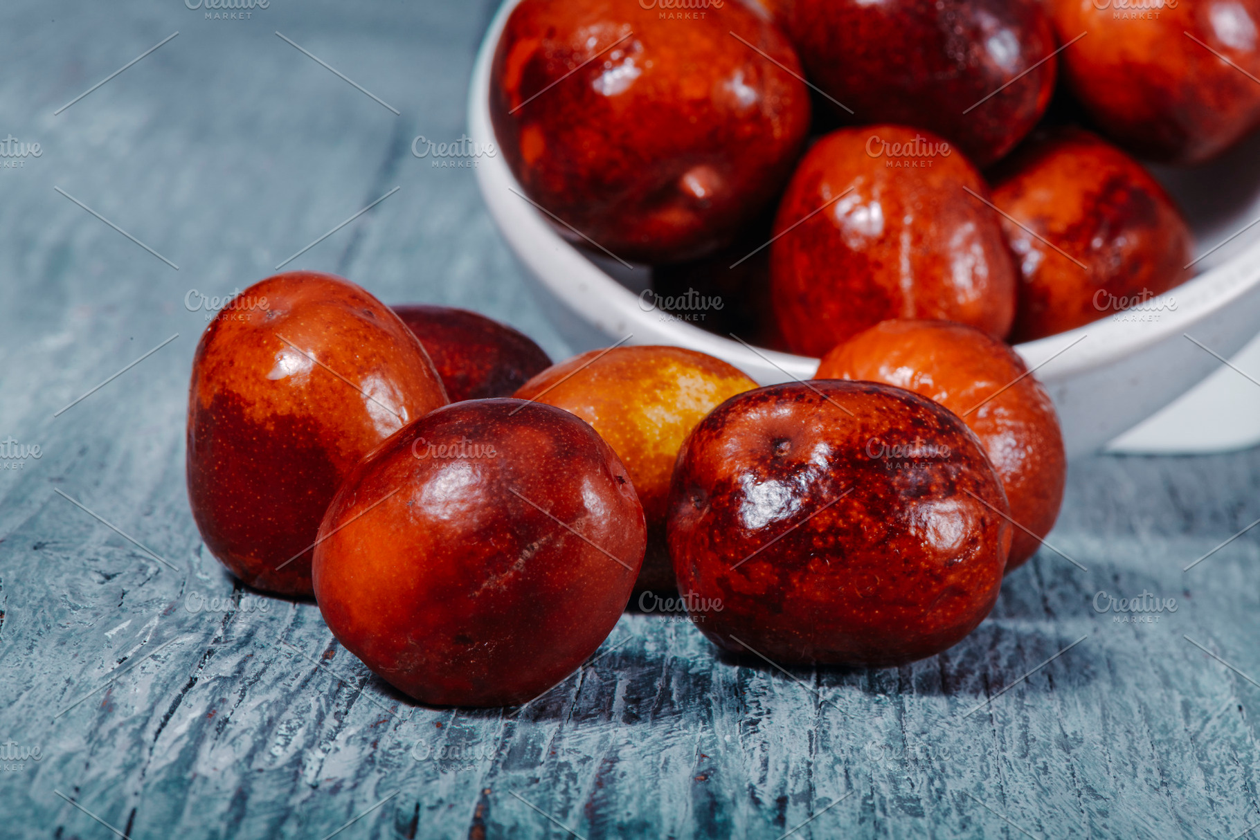 jujube fruits on a gray wooden table, a Photo by Nito