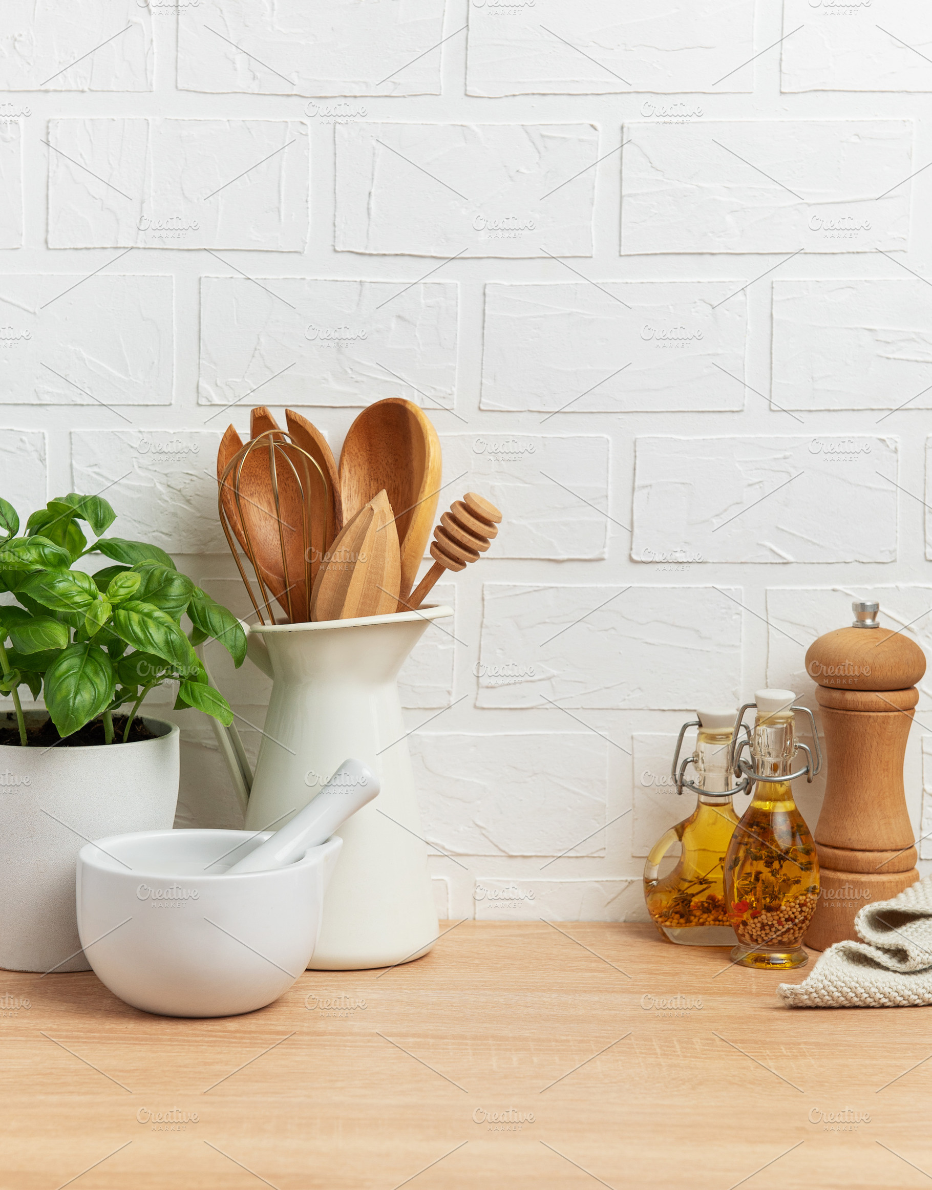 Kitchen utensils, fresh basil and mortar with pestle creating a, a Food & Drink Photo by Olena Rudo