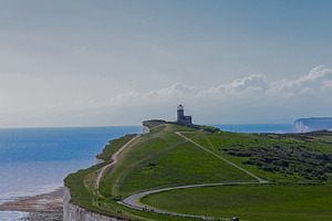 Belle Tout lighthouse providing guidance from a dramatic cliff, facing the vast, a Photo by Studio ANNA